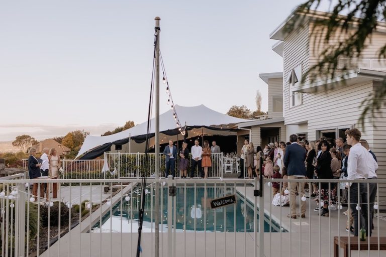 10x10m stretch tent in Minden, Tauranga, Bay of Plenty. Canopy rig with festoons reflecting in pool.